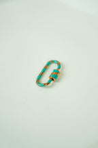 The carabiner ring with lock system (light blue and gold)
